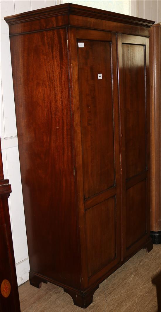 George III style mahogany two door panelled cupboard(-)